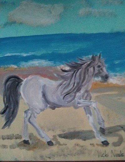 Horse gallops on beach